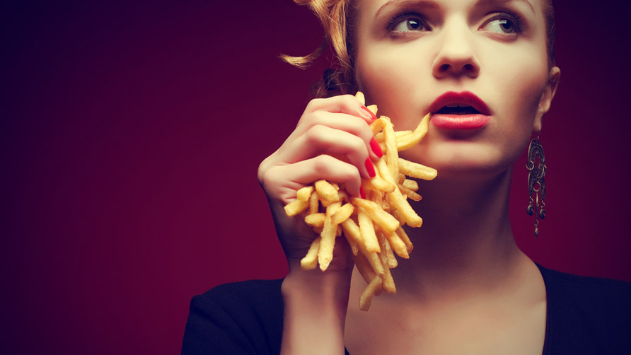 Woman holding French fries